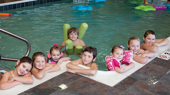 Kids lining a pool