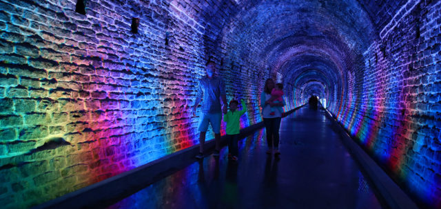 family exploring lighted brockville tunnel