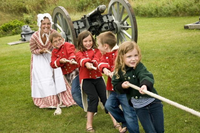 girls in historical attire doing tug of war