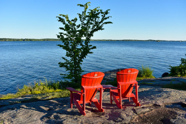 red chairs facing the water